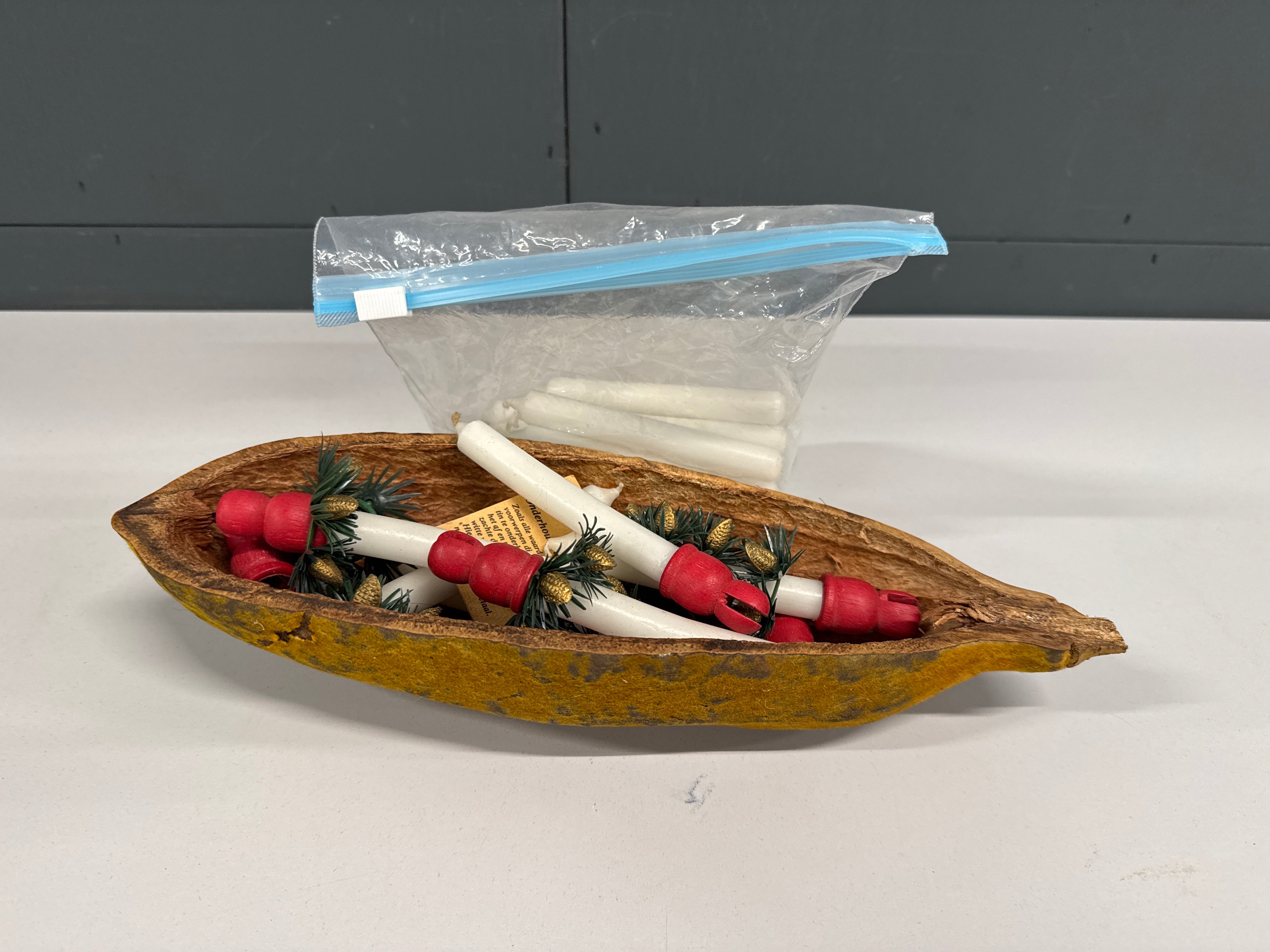 Kerstkaarsen en houders in vruchtschil